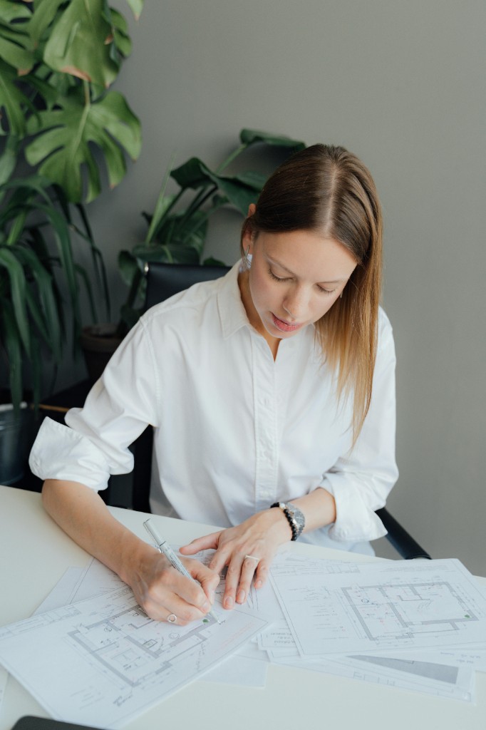 Architect reviewing floor plans at a studio desk